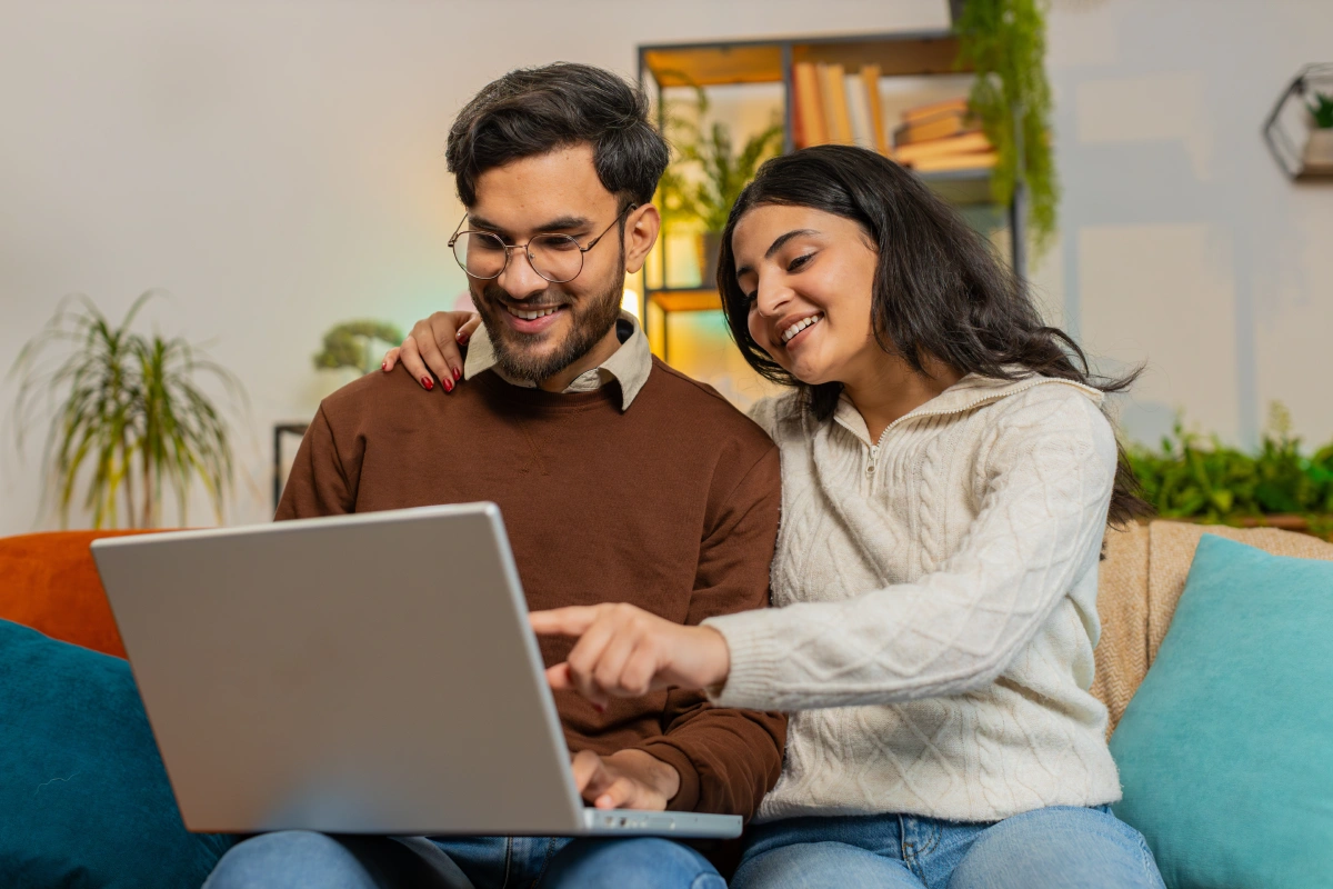 A couple using a laptop